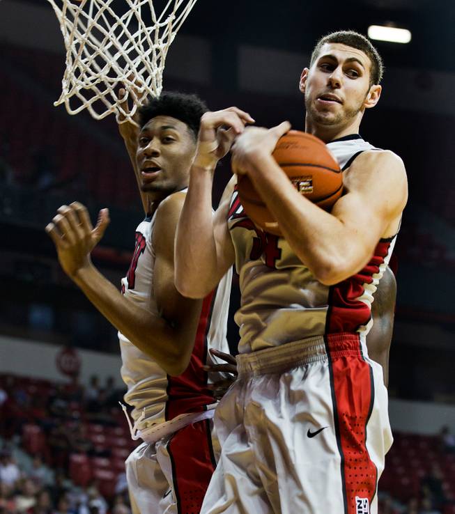 The UNLV basketball team's Christian Wood #5 and Ben Carter #13 team up for a rebound during the scarlet and gray exhibition game at the Thomas & Mack Center on Thursday, October 16, 2014. .