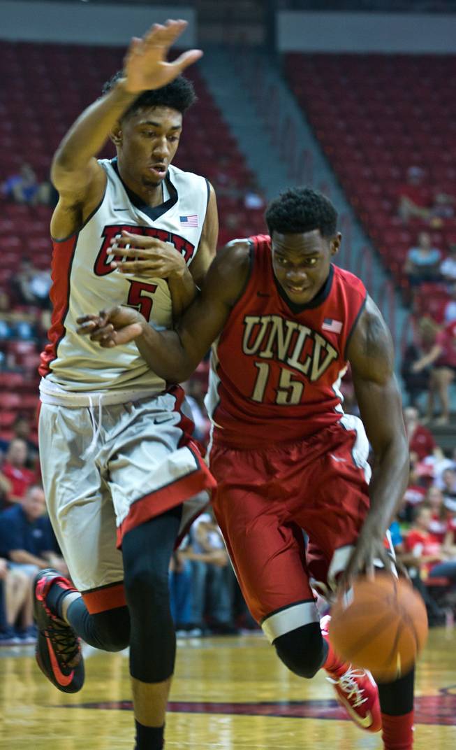 The UNLV basketball team's Christian Wood #5 defends against Dwayne Morgan #15 during the scarlet and gray exhibition game at the Thomas & Mack Center on Thursday, October 16, 2014. .