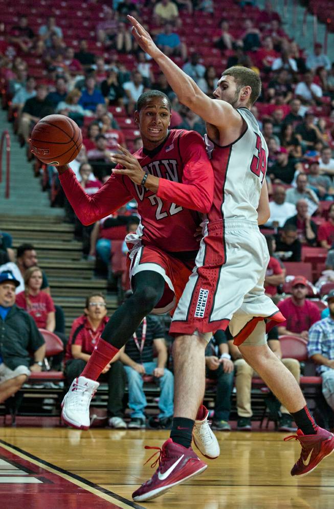 The UNLV basketball team's Jelan Kendrick #22 drives into Ben carter #34 while looking for a pass under the basket during the scarlet and gray exhibition game at the Thomas & Mack Center on Thursday, October 16, 2014. .