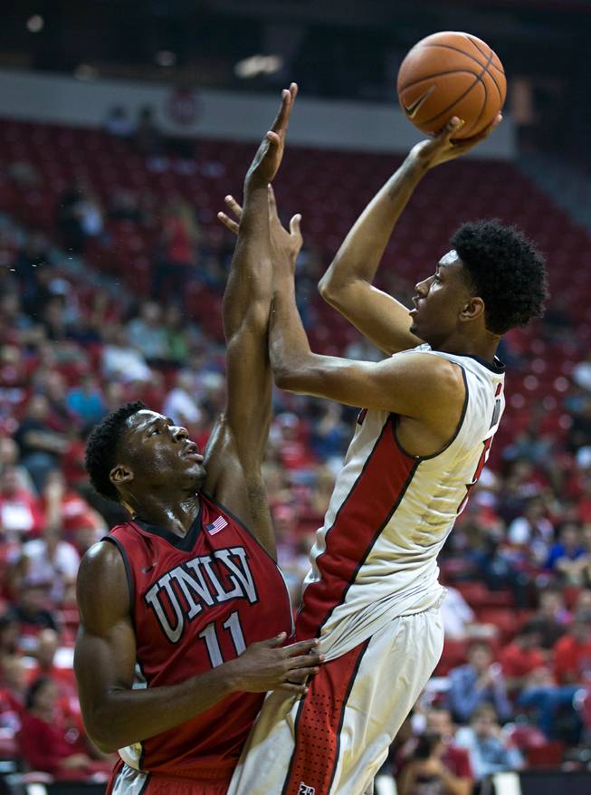 The UNLV basketball team's Goodluck Okonoboh #11 defends the hoop from Christian Wood #5 as he elevates for a shot during the scarlet and gray exhibition game at the Thomas & Mack Center on Thursday, October 16, 2014. .