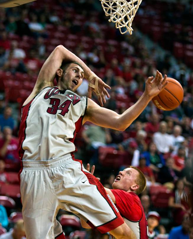 The UNLV basketball team's Ben Carter #13 goes after a rebound over Dantley Walker #30 during the scarlet and gray exhibition game at the Thomas & Mack Center on Thursday, October 16, 2014.