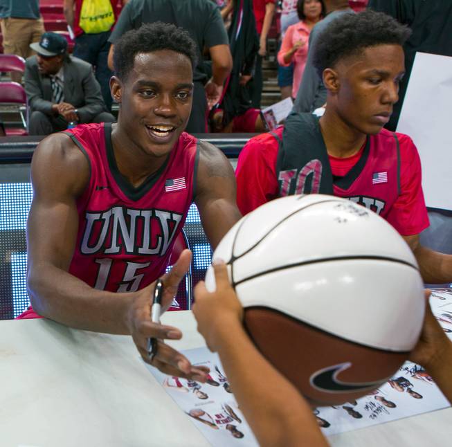 The UNLV basketball team's Dwayne Morgan (15) receives another ball to sign during an autograph session following the Scarlet & Gray Showcase at the Thomas & Mack Center on Thursday, Oct. 16, 2014.