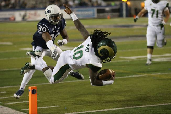 Colorado State's Dee Hart (10) dives past Nevada's Tere Calloway (30) into the end zone during the second half of an NCAA college football game in Reno, Nev., on Saturday, Oct. 11, 2014. (AP Photo/Cathleen Allison)