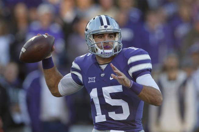 Kansas State quarterback Jake Waters (15) passes to teammate Tyler Lockett during the first half of an NCAA college football game against Texas Tech in Manhattan, Kan., Saturday, Oct. 4, 2014. (AP Photo/Orlin Wagner)