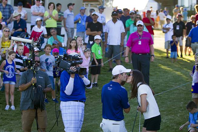 Kevin Streelman gets a kiss from his wife Courtney after finishing second in the Shriners Hospitals for Children Open golf tournament at TPC Summerlin Sunday, Oct. 19, 2014.