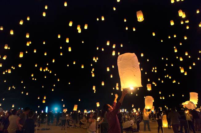Participants release their inflated lanterns during the Rise Lantern Festival at Jean Dry Lake Bed on Saturday, Oct. 18, 2014, in Jean.