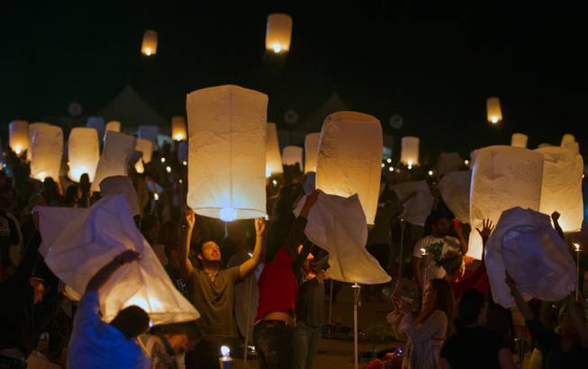 Participants inflate more lanterns and release them to the speckled sky during the Rise Lantern Festival at Jean Dry Lake Bed on Saturday, Oct. 18, 2014, in Jean.