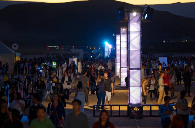 Participants make their way to their launch spots during the Rise Lantern Festival at Jean Dry Lake Bed on Saturday, Oct. 18, 2014, in Jean.