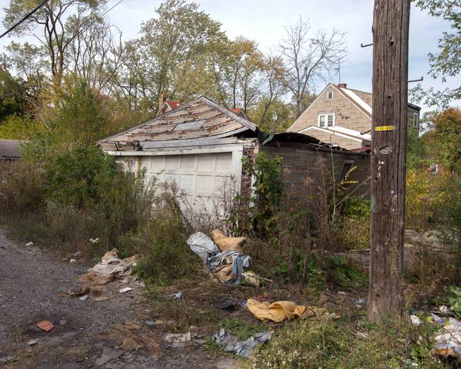 This Oct. 19, 2014, photo shows the back of a house in Gary, Ind., where the body of a woman was found on Sunday. Police said Sunday that a 43-year-old man confessed to killing a woman whose body was found in a Motel 6 in the neighboring city of Hammond, Ind., and told investigators where the bodies of three other women could be found in abandoned homes in Gary. Police said Monday that the bodies of seven women have now been found in northwestern Indiana.