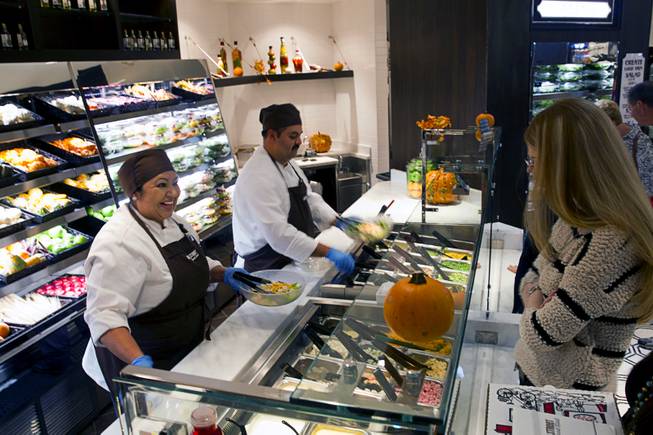 Giselda Flores and Mark Nelson create salads to order at the new Fulton Street Food Hall at Harrahs Las Vegas Wednesday, Oct. 22, 2014.