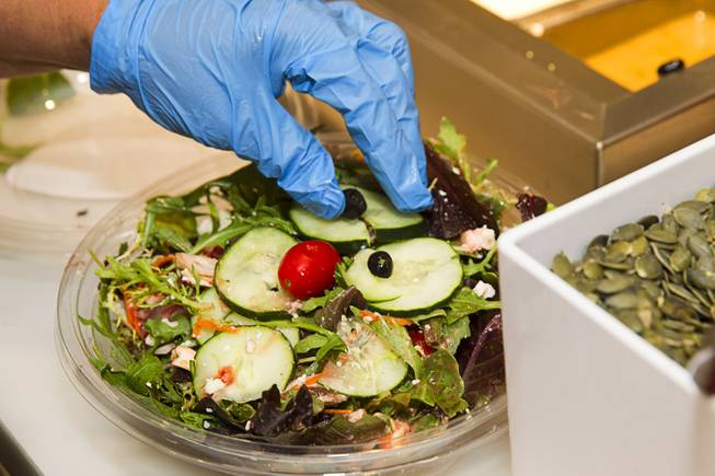 Giselda Flores create salad to order at the new Fulton Street Food Hall at Harrahs Las Vegas Wednesday, Oct. 22, 2014.