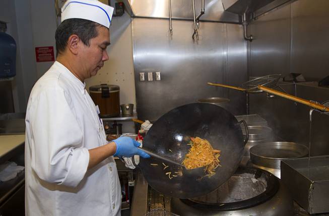 Ron Tong cooks an order of Pad Thai in a noodle station at the new Fulton Street Food Hall at Harrahs Las Vegas Wednesday, Oct. 22, 2014.
