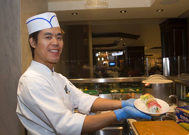 Guo Yan poses with a Rainbow Roll at the new Fulton Street Food Hall at Harrahs Las Vegas Wednesday, Oct. 22, 2014.