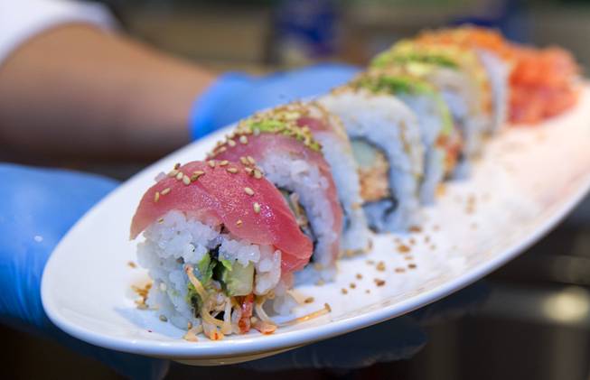 Chef Guo Yan poses with a Rainbow Roll at the new Fulton Street Food Hall at Harrahs Las Vegas Wednesday, Oct. 22, 2014.