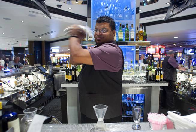 Fulton Street bartender Don Gardner mixes a Cucumber Cup cocktail in the new Fulton Street Food Hall at Harrahs Las Vegas Wednesday, Oct. 22, 2014.
