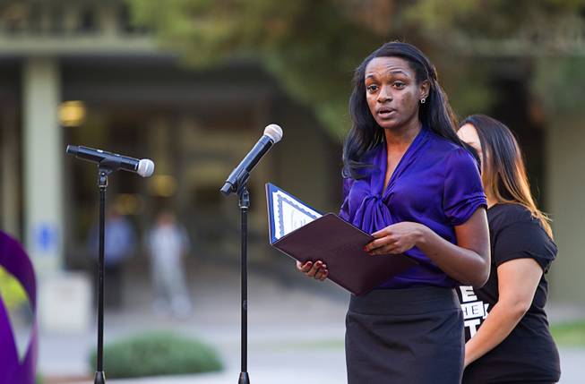 Simone Ruffin, representing Congresswoman Dina Titus (R-Nev.), reads a proclamation of congressional recognition during the 21st Annual Take Back the Night rally at UNLV Thursday, Oct. 23, 2014.