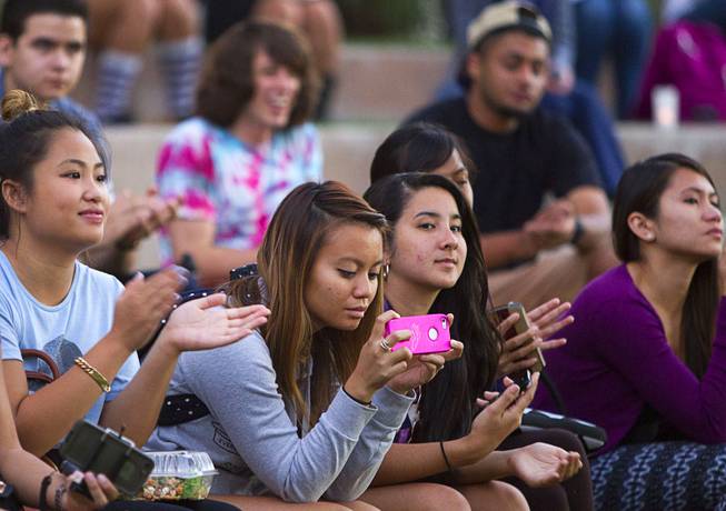 Geselle Rufin, center, and other members of the Alpha Phi Gamma sorority listen to speakers during the 21st Annual Take Back the Night rally at UNLV Thursday, Oct. 23, 2014. Alpha Phi Gamma's national philanthropy is the Fight Against Violence Towards Women, she said.