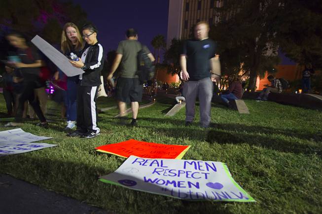Participants select signs prior to a march during the 21st Annual Take Back the Night rally at UNLV Thursday, Oct. 23, 2014.