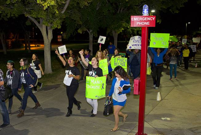 People chant as they march through campus during the 21st Annual Take Back the Night rally at UNLV Thursday, Oct. 23, 2014.  Christina Hernandez, director of Jean Nidetch Women’s Center at UNLV, said students are sometimes hesitant to be alert witnesses. The Women’s Center has taken a more active role in recruiting active bystanders by offering students golf cart rides to class while teaching them how to prevent sexual assault.