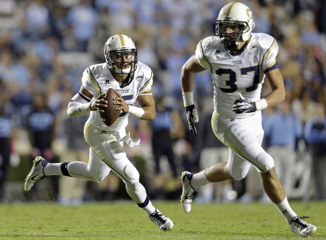 Georgia Tech quarterback Justin Thomas (5) rolls out as Zach Laskey (37) blocks during the first half of an NCAA college football game against North Carolina in Chapel Hill, N.C., Saturday, Oct. 18, 2014. (AP Photo/Gerry Broome)