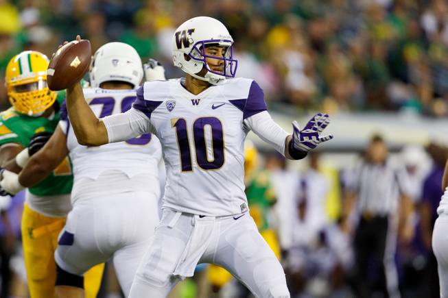 Washington quarterback Cyler Miles (10) looks to pass during the second quarter against Oregon in an NCAA college football game in Eugene, Ore., Saturday, Oct. 18, 2014. (AP Photo/Ryan Kang)