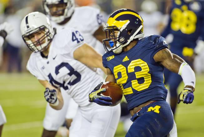 Penn State linebacker Mike Hull (43) defends Michigan wide receiver Dennis Norfleet (23) rushing in the first quarter of an NCAA college football game in Ann Arbor, Mich., Saturday, Oct. 11, 2014. Michigan won 18-13. (AP Photo/Tony Ding)