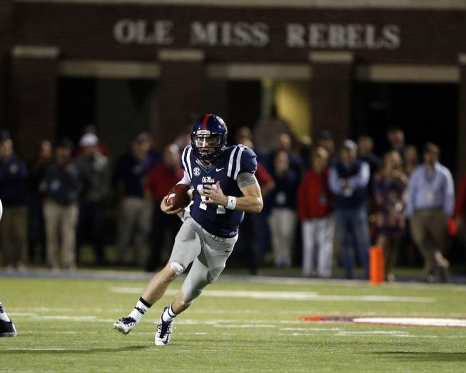 An unguarded Mississippi quarterback Bo Wallace (14) runs upfield in the second half of an NCAA college football game in Oxford, Miss., Saturday, Oct. 18, 2014. No. 3 Mississippi won 34-3. (AP Photo/Rogelio V. Solis)