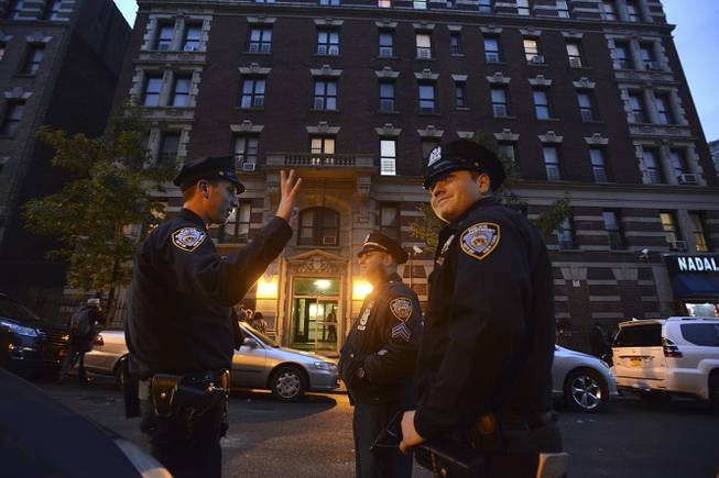 Police officers stand outside the apartment of Dr. , who tested positive for the Ebola virus Thursday, in the Harlem neighborhood of New York, Oct. 23, 2014. Spencer was rushed to Bellevue Hospital on Thursday and placed in isolation while health care workers spread out across the city to trace anyone who he might have come into contact with in recent days.