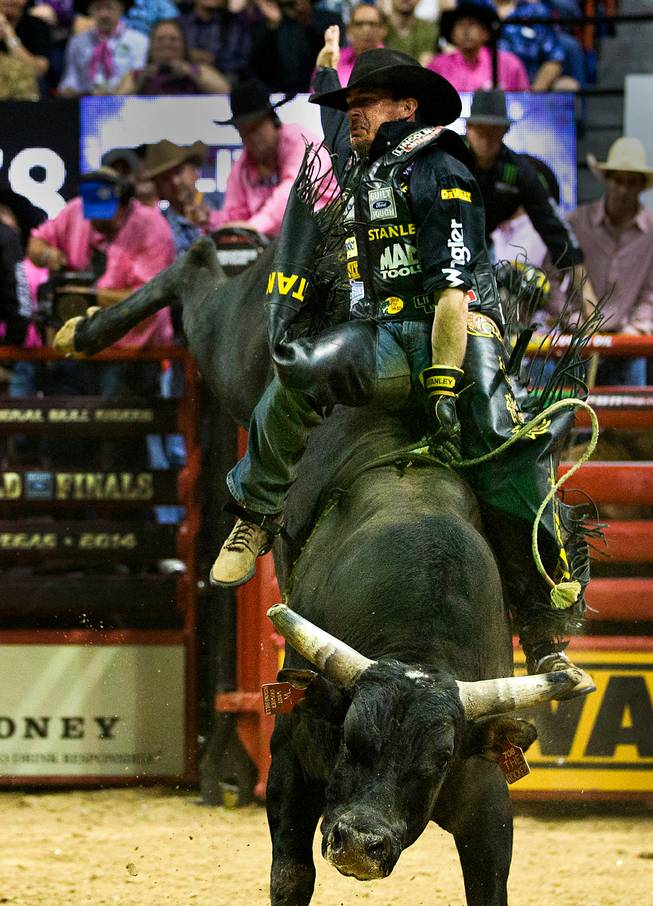 Kody Lostroh leans way back while still atop The Rocker during the PBR 2014 World Finals on Thursday, October 23, 2014. L.E. Baskow.