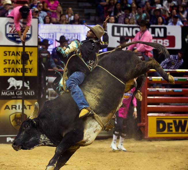 Claudio Crisostomo arches way back while atop I'm A Gangster Too during the PBR 2014 World Finals on Thursday, October 23, 2014. L.E. Baskow.