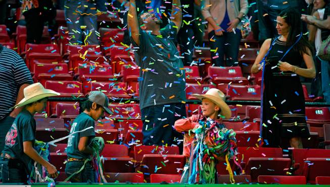 Young bull-riding fans gather up streamers following the PBR 2014 World Finals on Thursday, October 23, 2014. L.E. Baskow.