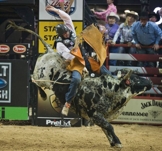 Tanner Bryne stays atop Superfreak during the PBR 2014 World Finals on Thursday, October 23, 2014. L.E. Baskow.