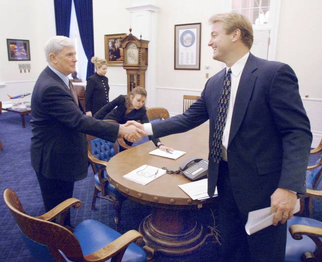 Nevada Gov. Kenny Guinn, left, and Secretary of State Dean Heller shake hands after a meeting in the Governor's office Tuesday, Feb. 4, 2003 at the Capitol Building in Carson City. In background from left are, Deputy Secretary for Elections Susan Bilyeu and Chief Deputy Secretary of State Renee Parker. AARON MAYES / LAS VEGAS SUN