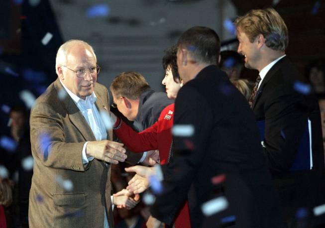 Vice President Dick Cheney greets local politicians and dignitaries onstage during a campaign rally at Green Valley High School in Henderson Monday, November 1, 2004. Nevada Secretary of State Dean Heller is at far right. 