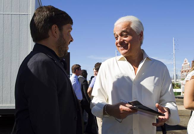 Rock in Rio founder Roberto Medina, right, talks with Rafael Lazarini, senior vice president of global business development for Rock in Rio, during a Rock in Rio news conference Monday, Oct. 27, 2014, in Las Vegas. The event was held to unveil a mock-up of Rock Street, one of three thematic streets that will be featured inside the City of Rock. The music festival venue at Las Vegas Boulevard South and Sahara Avenue opens in May 2015.