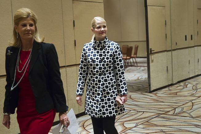 Elizabeth Smart, center, arrives for a news conference at the Rio Wednesday, Oct. 29, 2014. Melissa Warren, a managing partner of Faiss Foley Warren Public Relations, is at left. Smart is the keynote speaker for the Rape Crisis Center's Signs of Hope 40th anniversary dinner at the Rio.