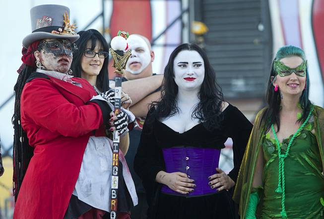 The "Ring Mistress," left, and other actors attend a wedding at the Freakling Bros.' Trilogy of Terror haunted house attraction Wednesday, Oct. 29, 2014. Jeff Burns aka Cardinal Sin, a longtime Freakling Bros. actor, married Michael Kimball, his longtime partner and a former Freakling Bros. actor.