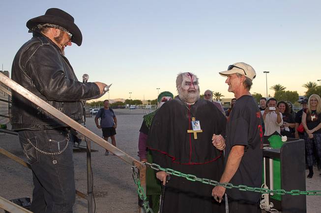 "Hellvis" officiates a wedding between Jeff Burns, left, aka Cardinal Sin, and Michael Kimball at the Freakling Bros.' Trilogy of Terror haunted house attraction Wednesday, Oct. 29, 2014.