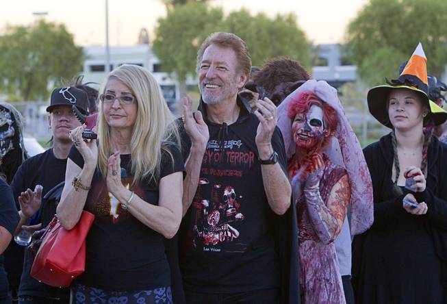 Duke Mollner, center, owner Freakling Bros., applauds during a wedding at the Freakling Bros.' Trilogy of Terror haunted house attraction Wednesday, Oct. 29, 2014. Jeff Burns aka Cardinal Sin, a longtime Freakling Bros. actor, married Michael Kimball, his longtime partner and a former Freakling Bros. actor.
