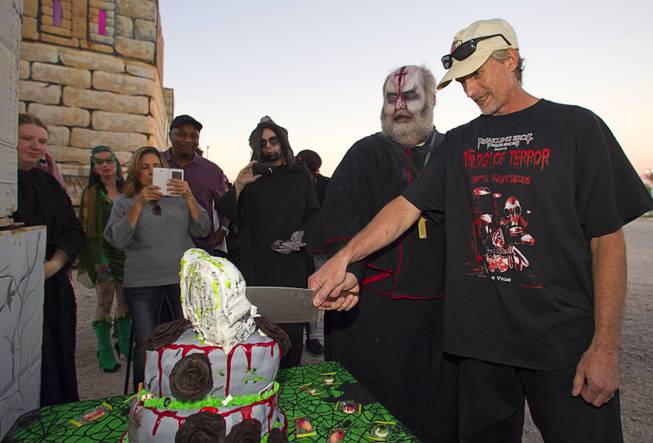 Jeff Burns, left, and his partner Michael Kimball cut a wedding cake after getting married at the Freakling Bros.' Trilogy of Terror haunted house attraction Wednesday, Oct. 29, 2014. Burns is a longtime Freakling Bros. actor who plays Cardinal Sin. Kimball is a former Freakling Bros. actor.
