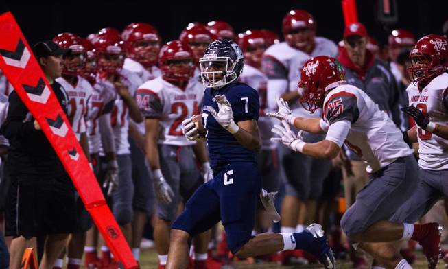 Centennial's Jamaal Evans 7 is chased onto the sidelines by Arbor View's Bryce Poster 15 on Thursday, October 30, 2014.