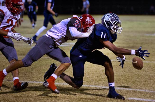 Centennial's Savon Scarver 11 can't seem to secure a critical pass as Arbor View's Charles Louch 21 hits him from behind on Thursday, October 30, 2014.