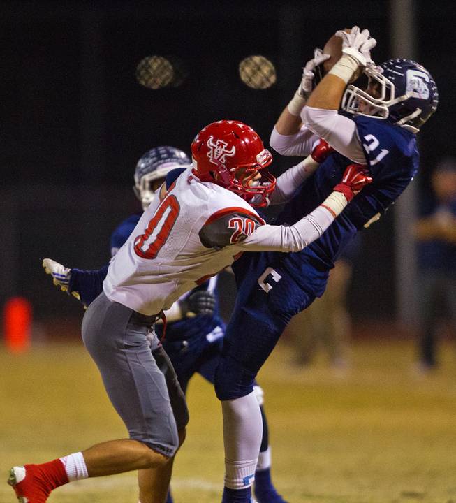 Arbor View's Michael Sims 20 collides with Centennial's Juan Puentes 31 knocking the ball loose on Thursday, October 30, 2014.