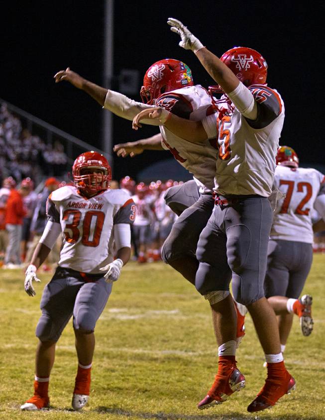 Arbor View's Herman Gray 34 celebrates his late-game touchdown with QB Bryce Poster 15 while facing Centennial on Thursday, October 30, 2014.