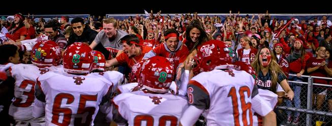 Arbor View fans celebrate their win over Centennial 21-16 with their players on Thursday, October 30, 2014.