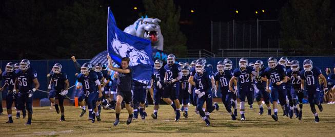 Centennial players and coaches take the field for their game versus Arbor View on Thursday, October 30, 2014.