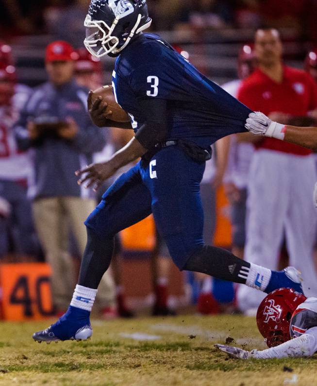 Centennial's Rhamondre Stevenson 3 is caught by his jersey by an Arbor View defender on Thursday, October 30, 2014.