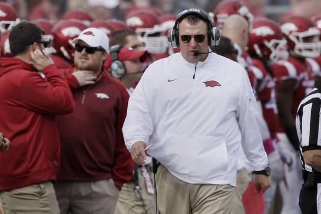 Arkansas coach Bret Bielema walks the sideline during the first quarter of an NCAA college football game against Georgia in Little Rock, Ark., Saturday, Oct. 18, 2014. (AP Photo/Danny Johnston)