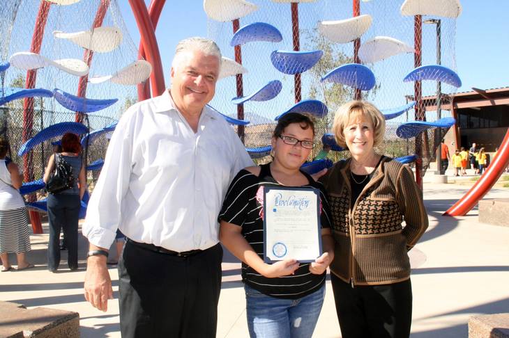 Mia Ramirez, 10, center, receives a proclamation from Clark County Commissioner Susan Brager for naming Mighty Mountain Fitness Area.