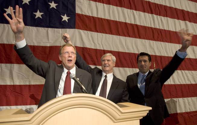 Rep. Jon Porter, Gov. Kenny Guinn and Attorney General Brian Sandoval hold up four fingers as they chant "four more years" after announcing that George Bush won Nevada during a Republican election night party at the Mandalay Bay on Tuesday, Nov. 2, 2004. Sandoval is the chairman of the Bush-Cheney 2004 Nevada Leadership Team and Porter and Guinn are co-chairmen. R. MARSH STARKS / LAS VEGAS SUN